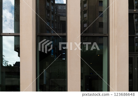 A contemporary glass structure refracts the energy of urban surroundings, blending architecture and daily life in a unique visual display. A contemporary glass structure refracts the energy of urban surroundings, blending architecture and daily life in a unique visual display. 123686648