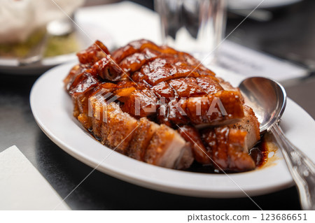 crispy pork and roasted duck is served with a caramelized glaze, embodying authentic Chinese barbecue flavors. crispy pork and roasted duck is served with a caramelized glaze, embodying authentic Chinese barbecue flavors. 123686651