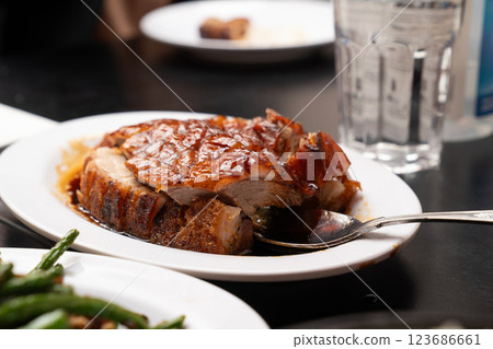 crispy pork and roasted duck is served with a caramelized glaze, embodying authentic Chinese barbecue flavors. crispy pork and roasted duck is served with a caramelized glaze, embodying authentic Chinese barbecue flavors. 123686661
