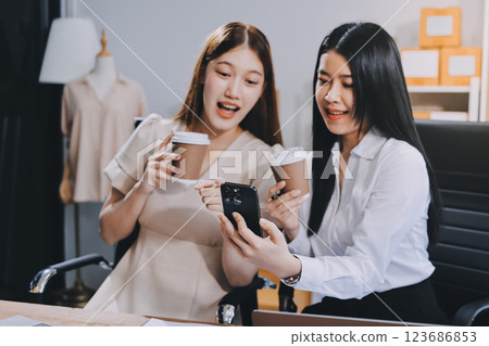 Startup SME small business entrepreneur of freelance Asian woman using a laptop with box Cheerful success Asian woman her hand lifts up online marketing packaging box and delivery SME idea concept 123686853
