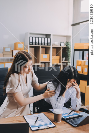 Startup SME small business entrepreneur of freelance Asian woman using a laptop with box Cheerful success Asian woman her hand lifts up online marketing packaging box and delivery SME idea concept Startup SME small business entrepreneur of freelance Asian woman using a laptop with box Cheerful success Asian woman her hand lifts up online marketing packaging box and delivery SME idea concept 123686910
