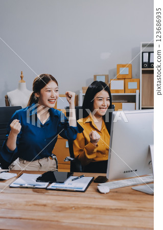 Asian SME business women use laptop computer checking customer order online shipping boxes at home. Starting Small business entrepreneur SME freelance. Online business, Work at home concept. Asian SME business women use laptop computer checking customer order online shipping boxes at home. Starting Small business entrepreneur SME freelance. Online business, Work at home concept. 123686935