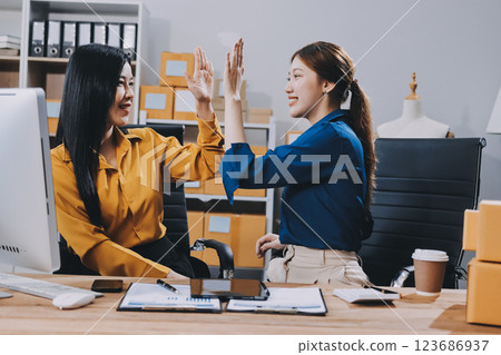 Asian SME business women use laptop computer checking customer order online shipping boxes at home. Starting Small business entrepreneur SME freelance. Online business, Work at home concept. 123686937
