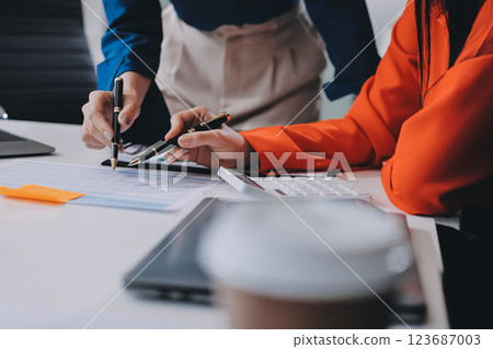Entrepreneur Asian businessman and businesswoman discussing new business project in tablet in modern Meeting In Modern Office, Asian business casual concept. 123687003