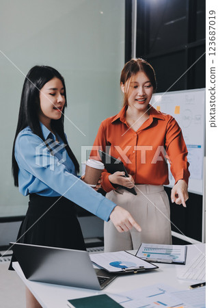 Entrepreneurs and business people conference in modern meeting room, happy multiracial coworkers have fun cooperating working together at office meeting, asian teamwork concept 123687019