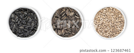 Bowl plates with healthy black and white sunflower seeds with shell isolated on white background. 123687461