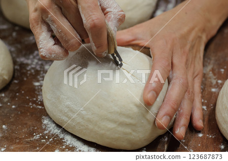 Bread making, cutting coupes into dough, bread making, shaping Bread making, cutting coupes into dough, bread making, shaping 123687873