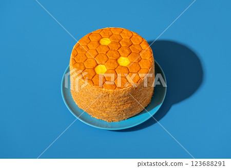 Honey cake called medovik, in bright light isolated on a blue background 123688291
