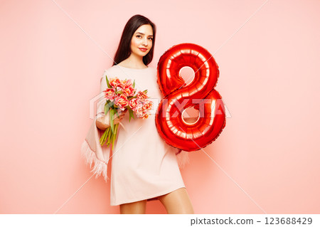 Woman hold bouquet of flowers and balloon number 8 Woman hold bouquet of flowers and balloon number 8 123688429