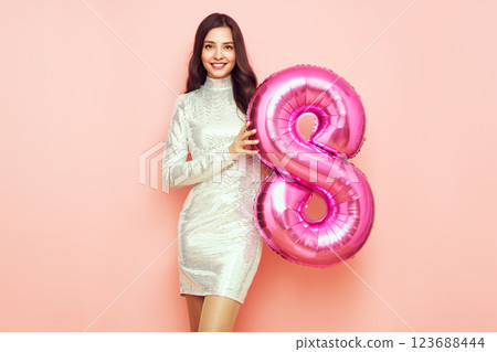 Beauty woman in a festive dress hold balloon number 8 Beauty woman in a festive dress hold balloon number 8 123688444