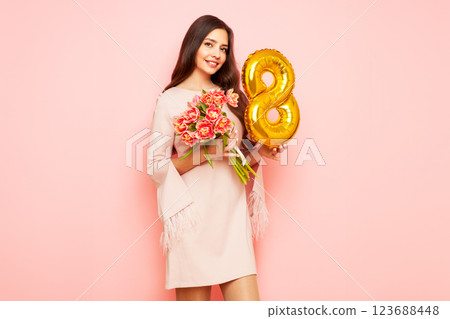 Woman hold bouquet of flowers and balloon number 8 123688448