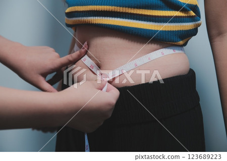 Women body fat belly. Obese woman hand holding excessive belly fat. diet lifestyle concept to reduce belly and shape up healthy stomach muscle. Women body fat belly. Obese woman hand holding excessive belly fat. diet lifestyle concept to reduce belly and shape up healthy stomach muscle. 123689223