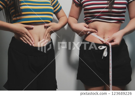 Women body fat belly. Obese woman hand holding excessive belly fat. diet lifestyle concept to reduce belly and shape up healthy stomach muscle. Women body fat belly. Obese woman hand holding excessive belly fat. diet lifestyle concept to reduce belly and shape up healthy stomach muscle. 123689226