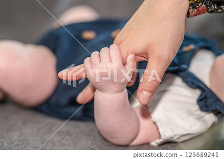 sweet tiny new born baby hand hold mum index finger. concept relationship between mother or parants and baby 123689241