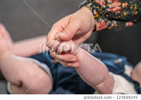sweet tiny new born baby hand hold mum index finger. concept relationship between mother or parants and baby sweet tiny new born baby hand hold mum index finger. concept relationship between mother or parants and baby 123689245