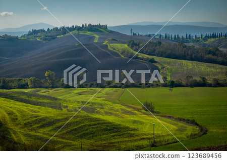 Rolling hills and vibrant fields in picturesque autumn countryside landscape 123689456