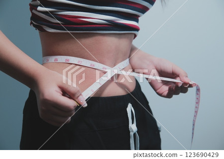 Women body fat belly. Obese woman hand holding excessive belly fat. diet lifestyle concept to reduce belly and shape up healthy stomach muscle. 123690429