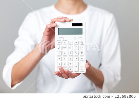 Middle-aged woman with a white calculator 123692806