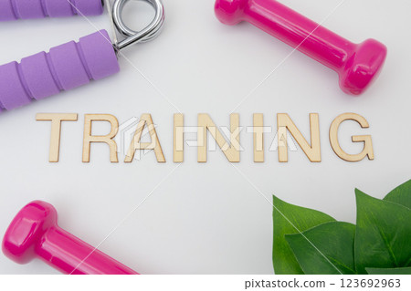 Dumbbells and hand grips with training text 123692963