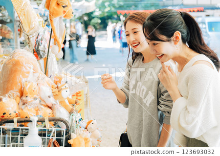 A woman (friend) choosing souvenirs from Nara 123693032