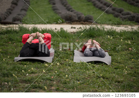 Enjoying a serene afternoon practicing yoga in the peaceful lavender fields while embracing tranquility and connection with nature 123693105
