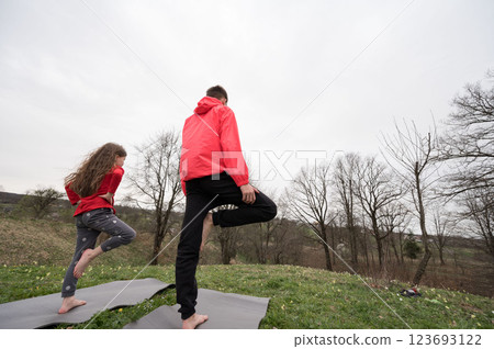 Start your joyful morning practice with a series of warm-up stretches, embraced by the tranquility of a serene outdoor setting filled with lush trees and the beauty of nature all around you Start your joyful morning practice with a series of warm-up stretches, embraced by the tranquility of a serene outdoor setting filled with lush trees and the beauty of nature all around you 123693122