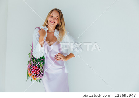 woman holding a bag with fresh vegetables and fruits in her hands woman holding a bag with fresh vegetables and fruits in her hands 123693948