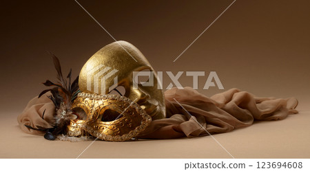 Golden Venetian carnival masks on a beige background. Golden Venetian carnival masks on a beige background. 123694608