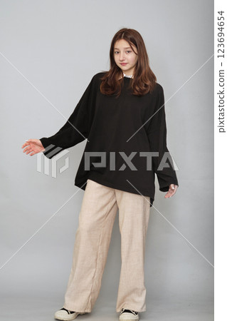 Thoughtful Teen in Customizable Hoodie, dressed in a high-quality black hoodie. The hoodie's plain backdrop is excellent for personalization, making it perfect for school brochures 123694654