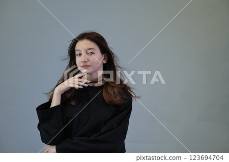 Hair flowing in the wind, a portrait of carefree spirit. Connects with the pursuit of happiness and natural beauty. 123694704