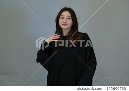 Intimate gesture of hair twirling, conveys the universal habit of pondering life's questions. Intimate gesture of hair twirling, conveys the universal habit of pondering life's questions. 123694760