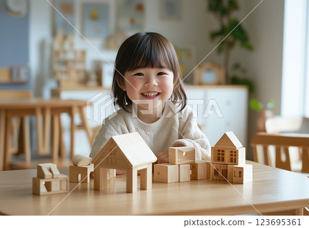 Toddler girl playing with building blocks 123695361