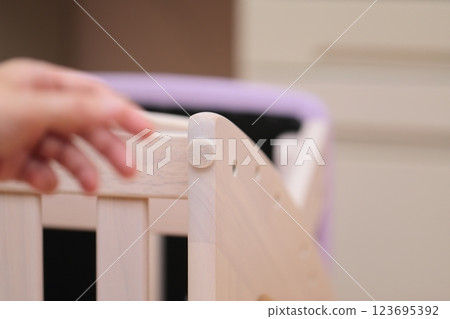 A man putting anti-scratch stickers on the legs of his desk chair A man putting anti-scratch stickers on the legs of his desk chair 123695392