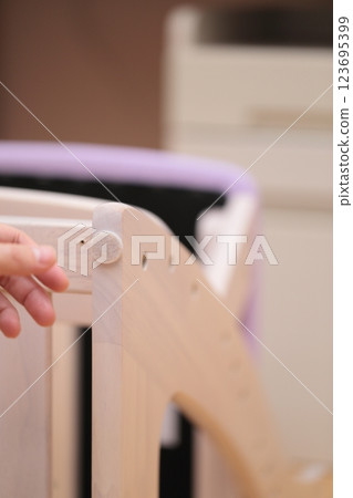 A man putting anti-scratch stickers on the legs of his desk chair A man putting anti-scratch stickers on the legs of his desk chair 123695399