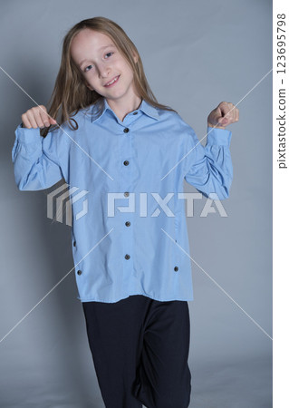 Delightful expression with heart-shaped hands, in soft blue. Reflects the warmth and positivity in children s fashion. 123695798