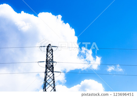 A simple landscape of blue sky, steel towers and clouds 123696451