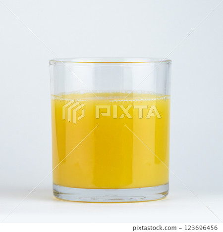 Freshly squeezed orange juice in a clear glass. High quality photo 123696456