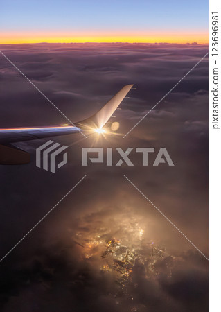 Outside the airplane window (sunset, night view and clouds) 123696981