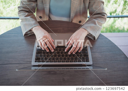 Woman working with computer laptop at cafe. Freelancer remote working from coffee shop. 123697542