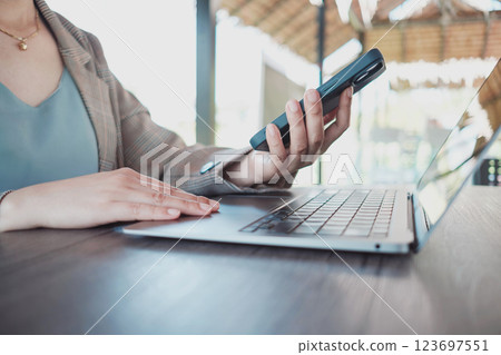 Close up female hands using smartphone shopping online, Freelancer remote working from coffee shop. Close up female hands using smartphone shopping online, Freelancer remote working from coffee shop. 123697551