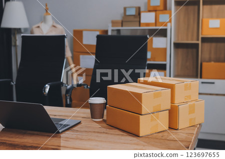 Asian SME business women use laptop computer checking customer order online shipping boxes at home. Starting Small business entrepreneur SME freelance. Online business, Work at home concept. Asian SME business women use laptop computer checking customer order online shipping boxes at home. Starting Small business entrepreneur SME freelance. Online business, Work at home concept. 123697655