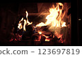 Burning fire logs inside stone fireplace. Close-up view. 123697819
