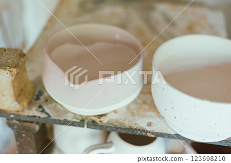 clay mugs in kiln for firing pottery clay mugs in kiln for firing pottery 123698210