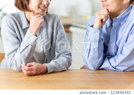 A middle-aged couple having a pleasant conversation in the living room 123698392