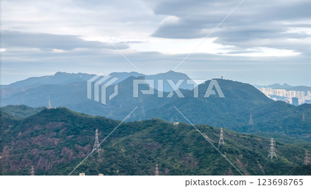 Feb 23 2025 Cityscape Surrounded by Lush Green Hills and Towering 123698765