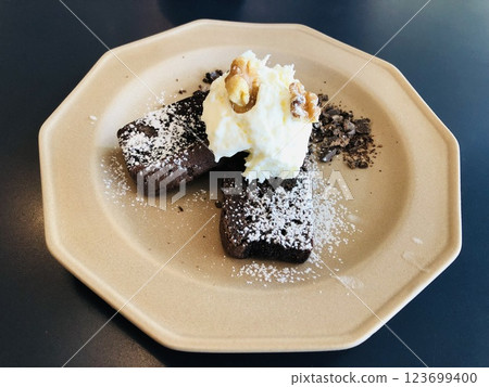 Chocolate cake topped with fresh cream and walnuts Chocolate cake topped with fresh cream and walnuts 123699400