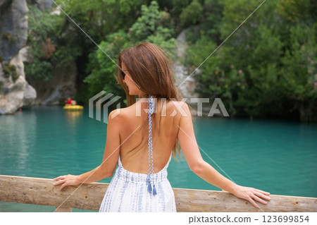 Woman enjoying canyon view by turquoise water 123699854
