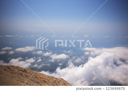 High mountain summit view above clouds with distant coastline 123699870