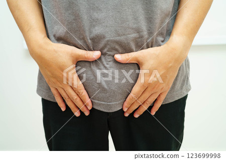 Hernia, Asian man stomach ache, abdominal pain and urology problem health. 123699998