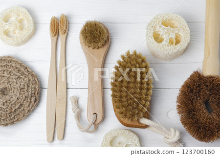 Brushes for dry lymph massage and toothbrushes made of natural materials. Eco-friendly personal care products on a white background. Brushes for dry lymph massage and toothbrushes made of natural materials. Eco-friendly personal care products on a white background. 123700160